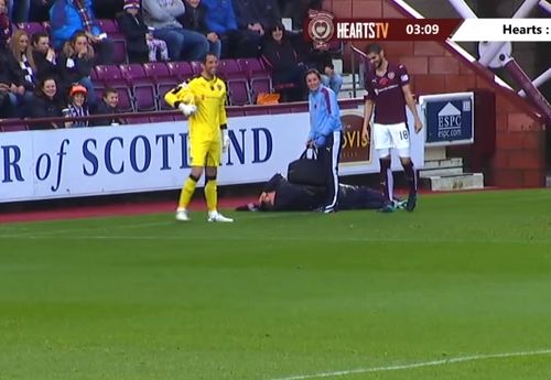 An injured ball boy at Heart of Midlothian gets treatment after his slip and fall during a game against Hamilton