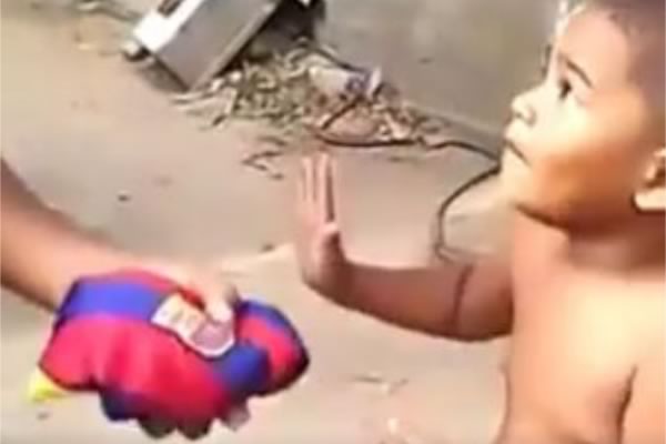 A boy refuses a Barcelona shirt before taking a Real Madrid shirt instead