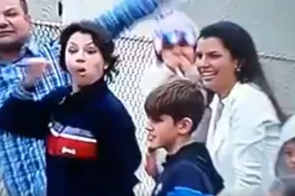 An Atlético Paranaense supporter makes a rude gesture to camera at a game, mimicking an oral sex act
