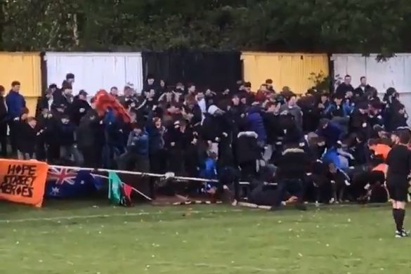 Prescot Cables fans collapse fence celebrating goal against Southport in Liverpool Senior Cup Final at Volair Park