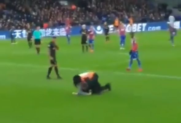 Pitch invader is tackled by a steward during Crystal Palace 1-1 Newcastle