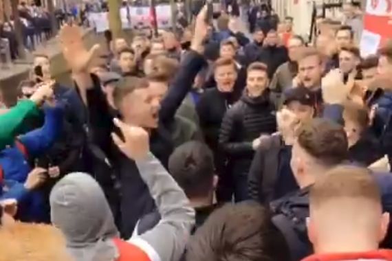 England fans cheer a supporter leaving an Amsterdam brothel