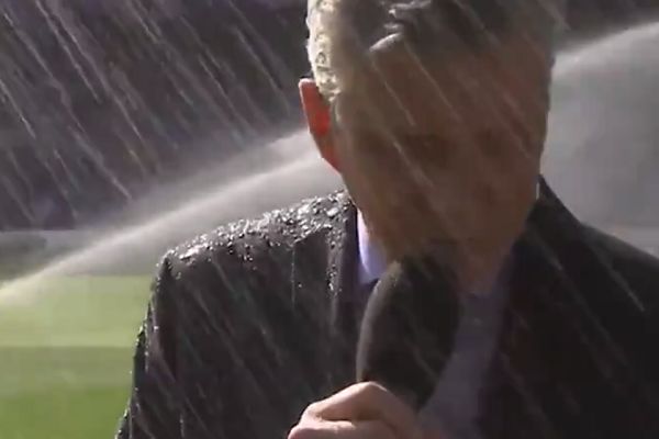 Boxing announcer Michael Buffer is sprayed by a sprinkler while reading the teams out before Chelsea vs Liverpool at Stamford Bridge