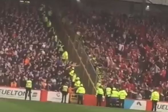 Aberdeen fans rush to side of stand at Pittodrie Stadium to jeer at Rangers supporters after taking the lead in 1-1 draw