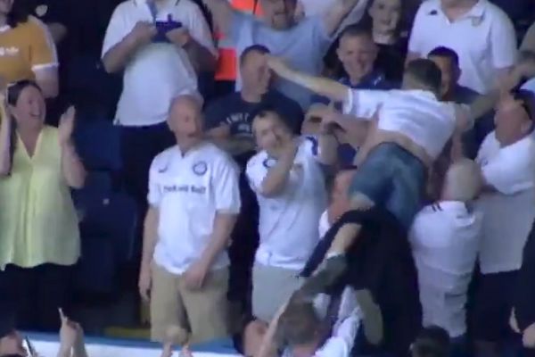 A Leeds fan crowd surfs in the stands during their 2-0 win over QPR at Elland Road