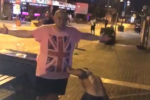 A Rangers fan smashes a glass bottle over his own head in Cyprus after their Europa League first qualifying round second leg clash against FK Shkupi