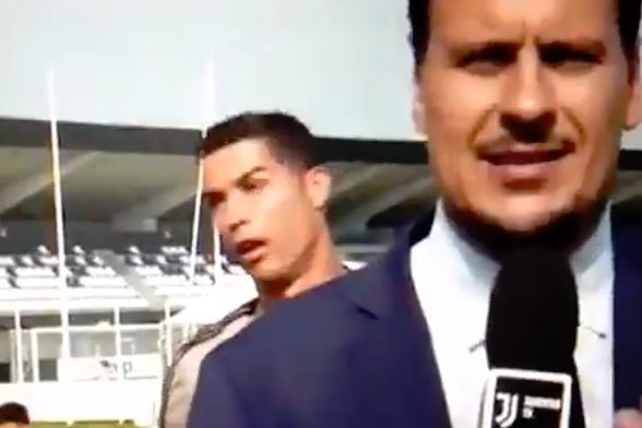Cristiano Ronaldo imitates a Juventus reporter while standing behind him at the training ground
