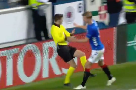 Joe Worrall pushes the additional assistant referee during Rangers 3-1 Rapid Wien in the Europa League