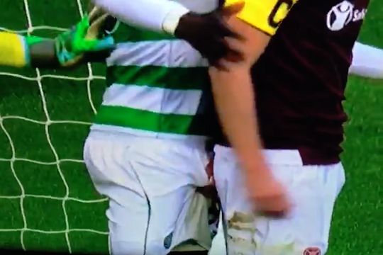 Heart's Steven MacLean grabs Celtic's Eboue Kouassi in the balls
