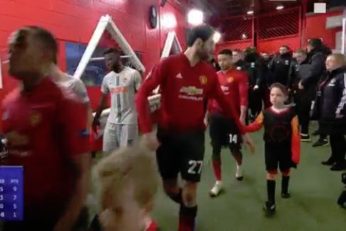 Marouane Fellaini loses his mascot as the teams walk out of the tunnel for Man Utd's 1-0 Champions League win over Young Boys