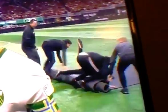 Staff trip and fall over as they try to roll up the carpet following the pre-match handshakes in the MLS Cup final