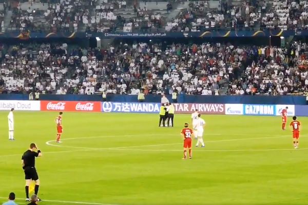 Pitch invader tries to hug Real Madrid players during their 3-1 win over Kashima Antlers in a Club World Cup semi-final