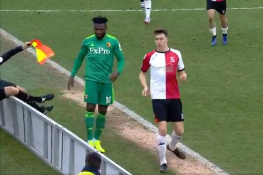 Assistant referee falls backwards over the advertising hoardings at Woking's Kingfield Stadium in an FA Cup loss to Watford