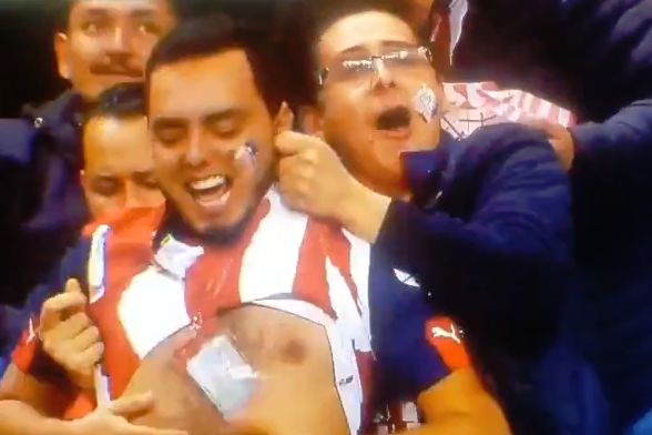 Guadalajara fan lifts up another fan's shirt after goal against Cafetaleros de Tapachula in Copa MX