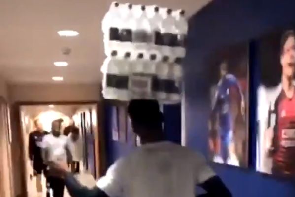 Leicester City's Kelechi Iheanacho balances a multipack of water bottles on his head