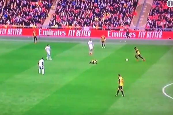 Étienne Capoue lies down so Adrian Mariappa can pass the ball over him during Watford 3-2 Wolves in the FA Cup semi-finals