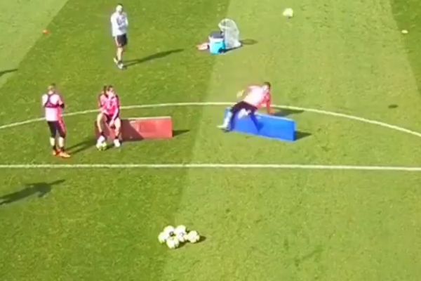 Kylian Mbappé falls backwards over a board during a Paris Saint-Germain training session