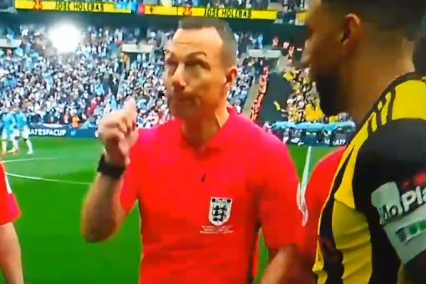 Referee Kevin Friend flicks a coin over his head accidentally during the toss before Man City v Watford in the FA Cup final