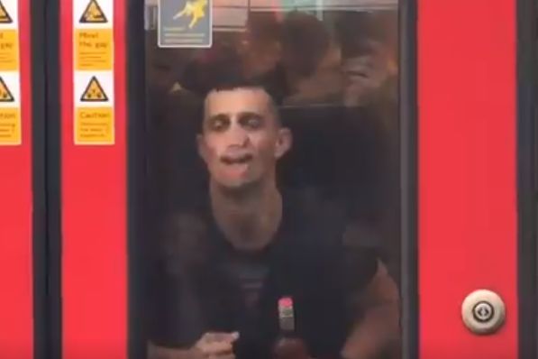 Manchester City fan rubs lips up and down window of a tube train while celebrating 6-0 FA Cup final victory over Watford