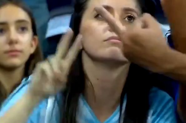 Argentina fan flashes a middle finger in woman's face during Argentina vs Paraguay in the Copa América