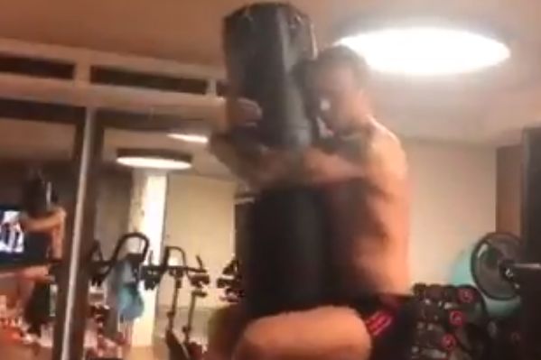 Dimitar Berbatov swings from a punch bag in a gym while lamenting the lack of Premier League fixtures