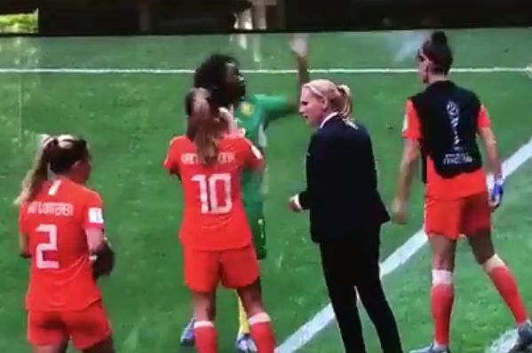 Cameroon's Gabrielle Onguéné throws away a water bottle offered to her by a Netherlands substitute during a Women's World Cup match