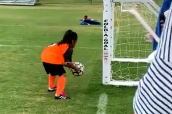 Young girls picks up ball to have another shot after her first shot goes wide