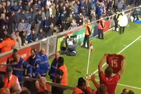 Lincoln City fan holds up a Liverpool shirt at Everton during Carabao Cup match
