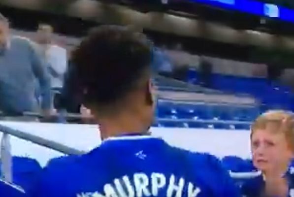 Cardiff City's Josh Murphy gives a crying boy his matchday shirt following the 1-1 draw against Fulham