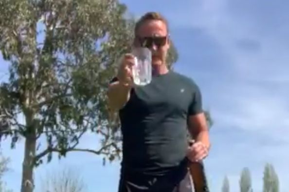 Ray Parlour attempts to pour beer into glass balancing on his foot