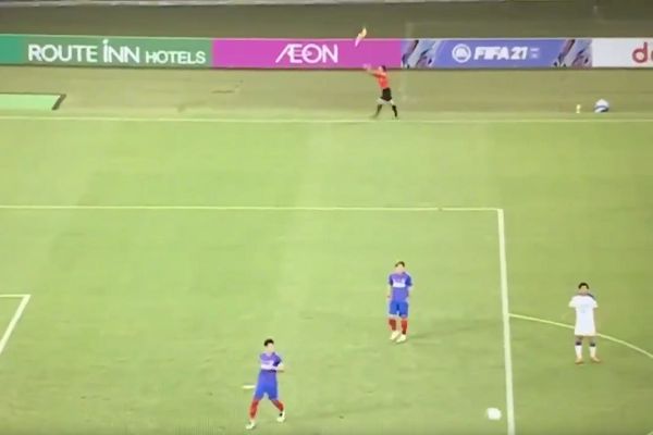 Assistant referee throws flag up into the air at Tokyo vs Oita Trinita
