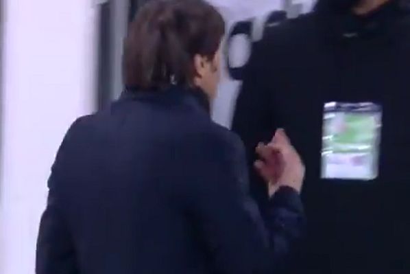 Inter manager Antonio Conte shows his middle finger to Juventus president Andrea Agnelli during half-time of Coppa Italia semi-final