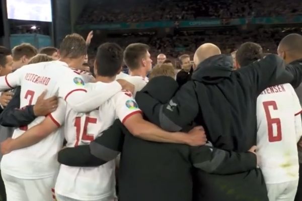 Denmark squad huddle together and check phone to see if they'd qualified from Group B after 4-1 win over Russia at Euro 2020